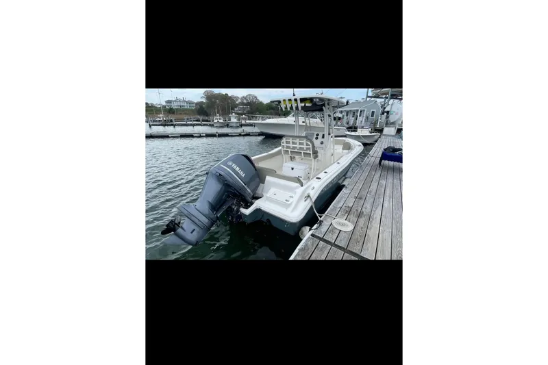 Slide: The Image of 2022 Key West 239 FS boat docked with Yamaha outboard motor. - 10