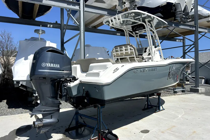 Slide: The Image of 2022 Key West 239 FS boat with Yamaha engine on display in storage facility. - 11