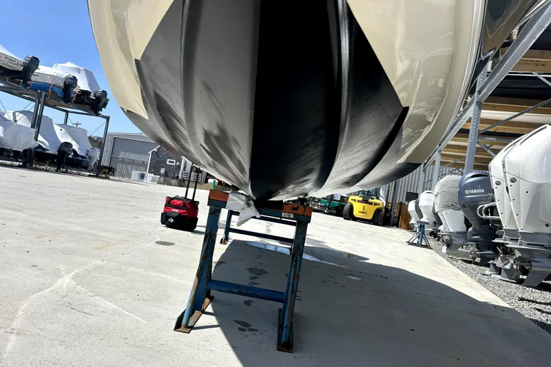 Slide: The Image of 2022 Key West 239 FS boat hull on stand in marina storage area. - 12