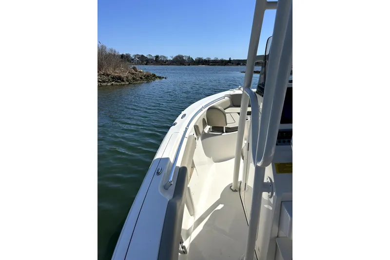 Slide: The Image of 2022 Key West 239 FS boat on calm water, showcasing sleek design and spacious deck. - 3