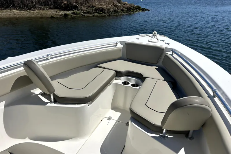 Slide: The Image of 2022 Key West 239 FS boat interior with cushioned seating and cup holders. - 5