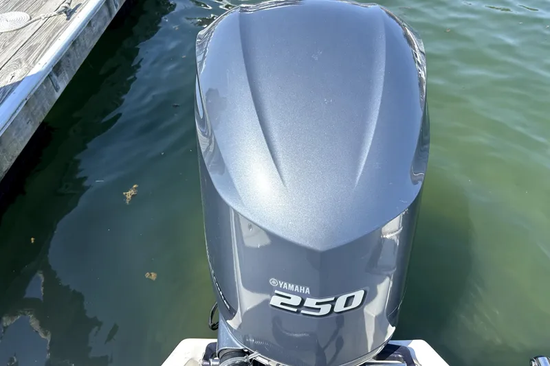 Slide: The Image of Yamaha 250 outboard motor on 2022 Key West 239 FS boat, docked in calm water. - 9