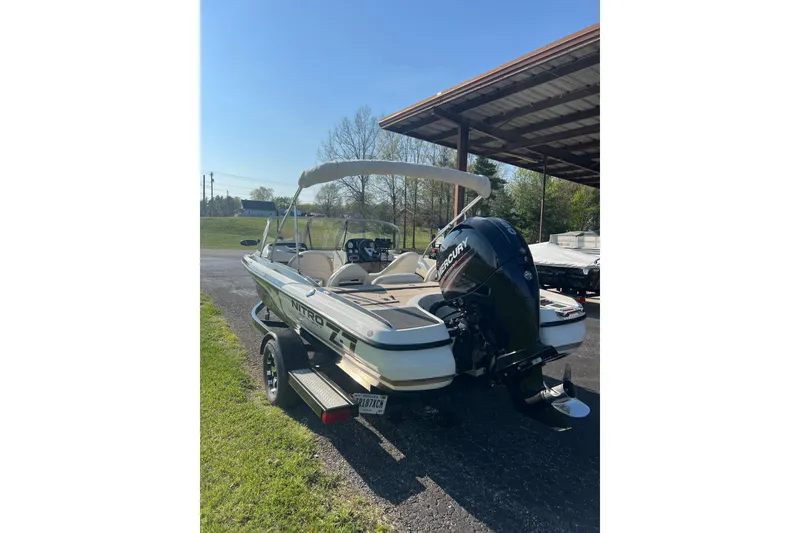 Slide: The Image of 2013 Nitro Z-7 Sport boat with Mercury engine, parked outdoors under clear sky. - 3