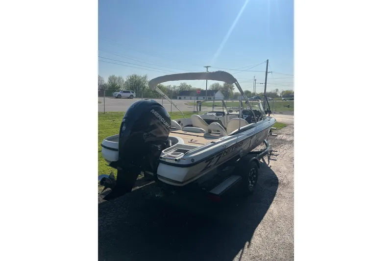 Slide: The Image of 2013 Nitro Z-7 Sport boat with Mercury engine, parked outdoors on a sunny day. - 4
