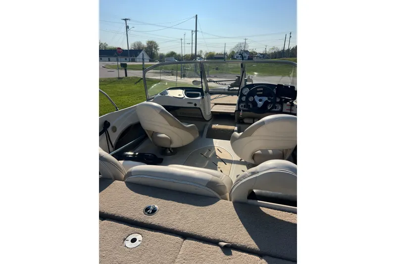 Slide: The Image of 2013 Nitro Z-7 Sport boat interior with beige seating and steering console. - 5