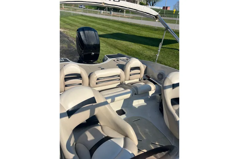 Slide: The Image of 2013 Nitro Z-7 Sport boat interior with beige seating and outboard motor. - 6