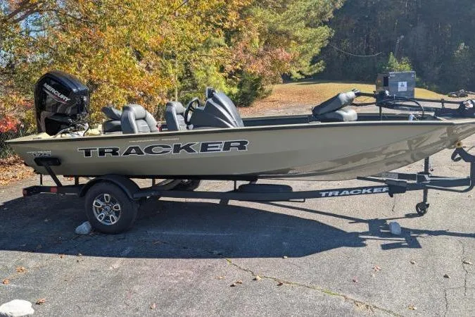 The Image of 2026 Tracker Pro Team 175 boat on trailer, parked outdoors with autumn foliage. - 0
