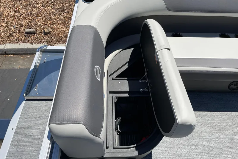 Slide: The Image of 2026 Sun Tracker Bass Buggy 16 XL Select boat seat with storage compartment open. - 16