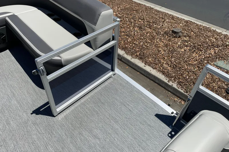 Slide: The Image of 2026 Sun Tracker Bass Buggy 16 XL Select pontoon boat interior with seating and open gate. - 11