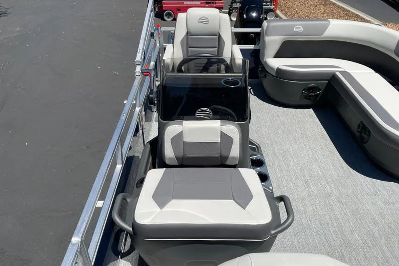 Slide: The Image of 2026 Sun Tracker Bass Buggy 16 XL Select pontoon boat interior with gray seating and steering console. - 25