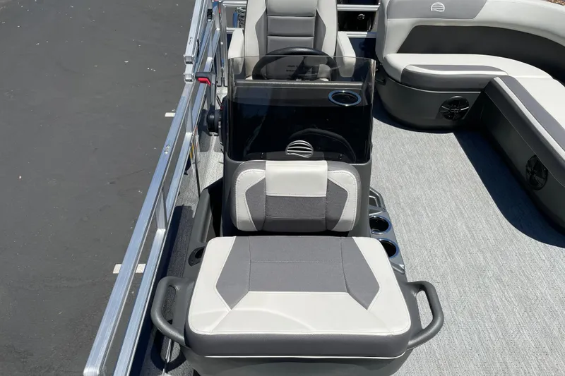 Slide: The Image of 2026 Sun Tracker Bass Buggy 16 XL Select pontoon boat interior with seating and steering console. - 24