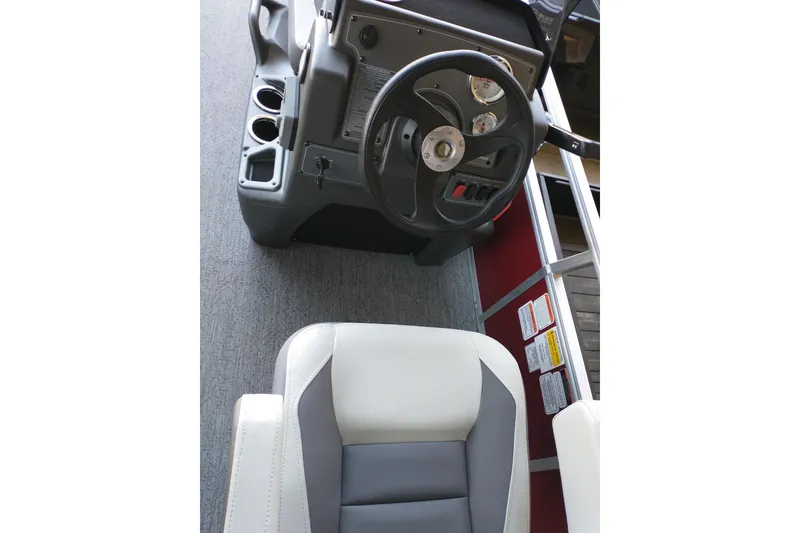Slide: The Image of Interior view of 2026 Sun Tracker Bass Buggy 18 DLX boat's steering console and seat. - 7