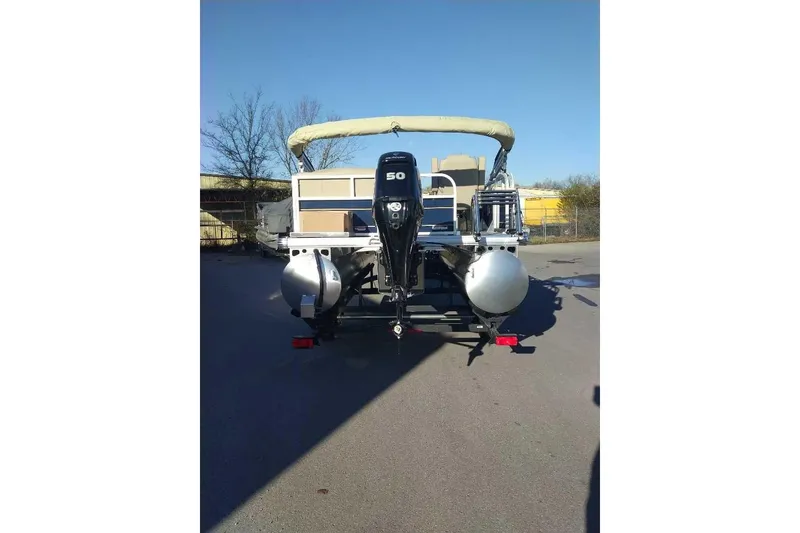 Slide: The Image of 2026 Sun Tracker Bass Buggy 16 XL Select pontoon boat with 50 HP engine, rear view. - 3
