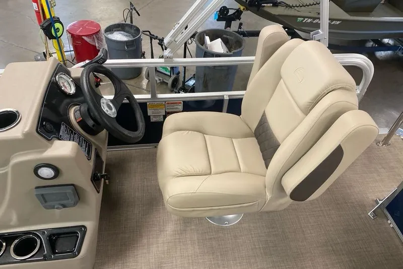 Slide: The Image of 2026 Sun Tracker Bass Buggy 16 XL Select boat interior with beige captain's chair and steering console. - 4