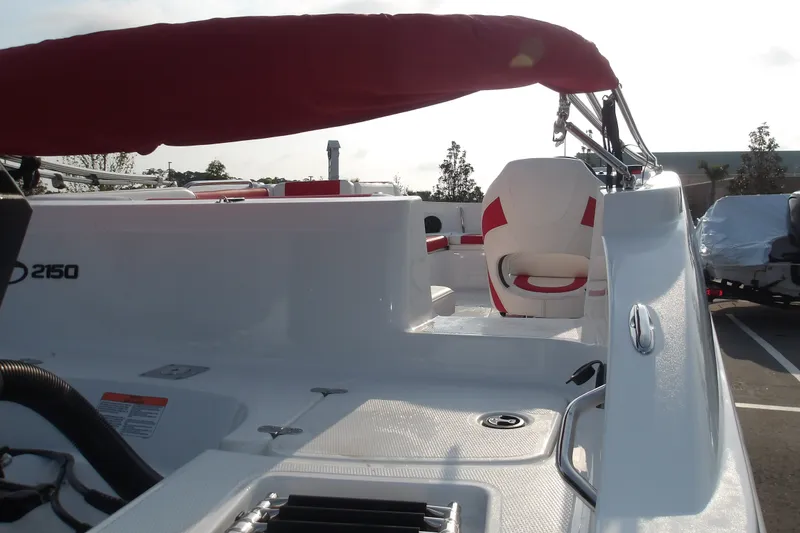 Slide: The Image of 2026 Tahoe 2150 boat interior with red and white seating, under a sunny sky. - 9