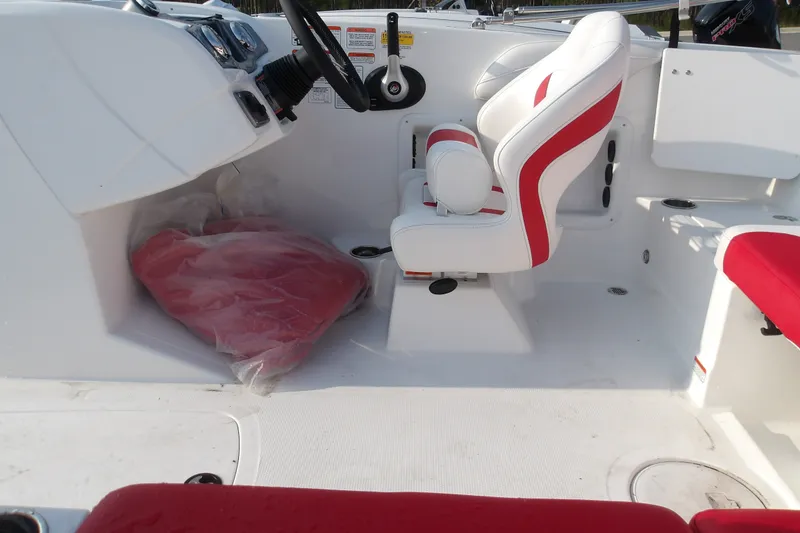 Slide: The Image of Interior of 2026 Tahoe 2150 boat with white and red seating, steering console. - 17