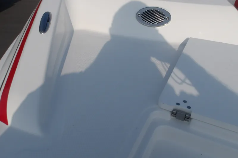 Slide: The Image of 2026 Tahoe 2150 boat deck with red trim and ventilation grille. - 13