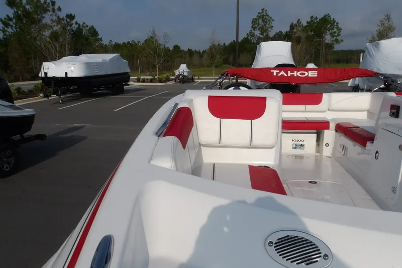 Slide: The Image of 2026 Tahoe 2150 boat with red and white interior, parked outdoors. - 11