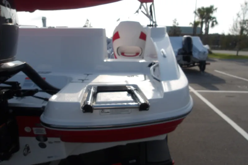 Slide: The Image of 2026 Tahoe 2150 boat with swim platform and ladder in a parking lot. - 8