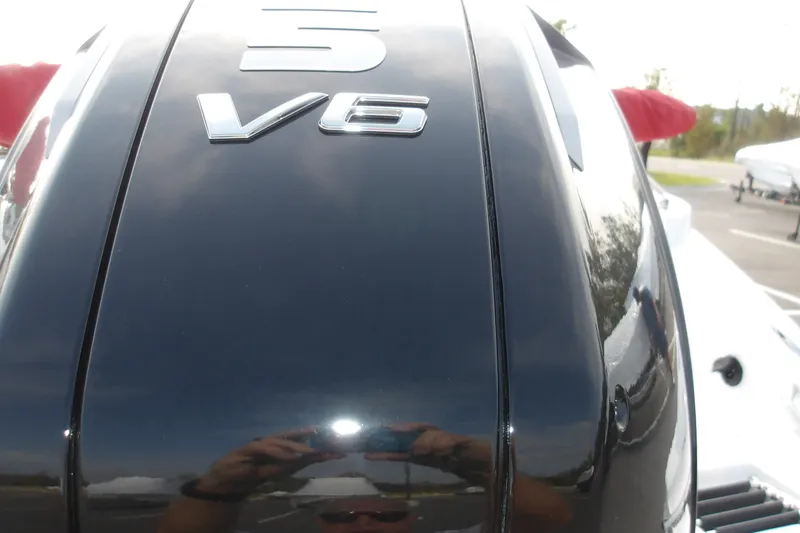 Slide: The Image of Close-up of a 2026 Tahoe 2150 V6 engine cover, reflecting surroundings. - 6
