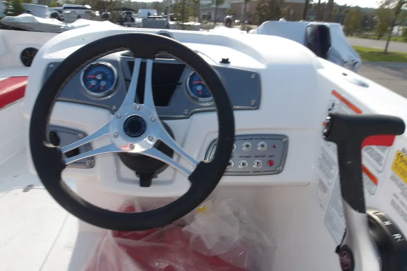Slide: The Image of Steering console of a 2026 Tahoe 2150 boat with gauges and controls. - 15