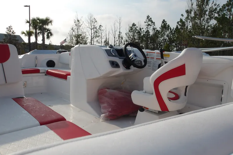 Slide: The Image of 2026 Tahoe 2150 boat interior with red and white seating, steering wheel, and dashboard. - 16