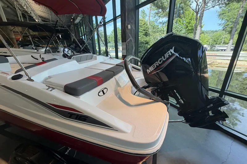 Slide: The Image of 2026 Tahoe T16 boat with Mercury engine displayed indoors near large windows. - 10