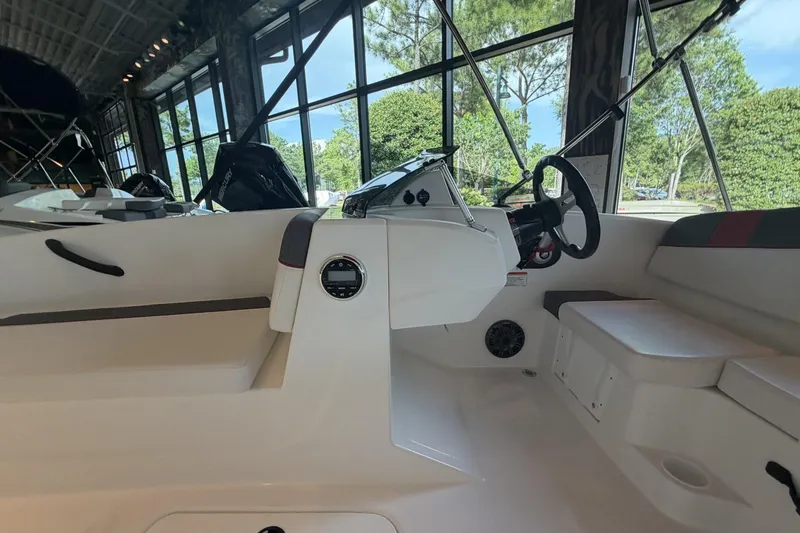 Slide: The Image of Interior view of 2026 Tahoe T16 boat, showcasing steering console and seating area. - 6