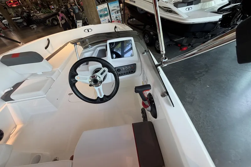Slide: The Image of Interior view of a 2026 Tahoe T16 boat, showcasing steering wheel and control panel. - 8