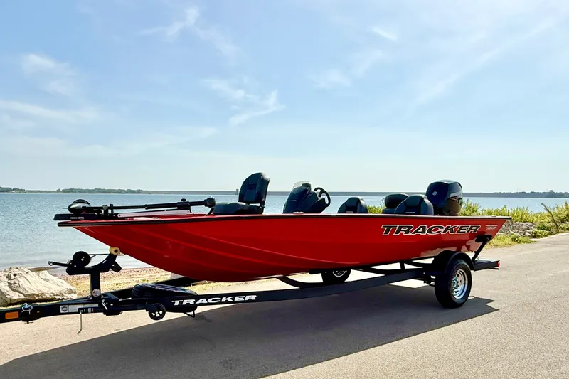 Slide: The Image of 2026 Tracker Pro Team 195 boat on trailer by a scenic lakeside. - 66