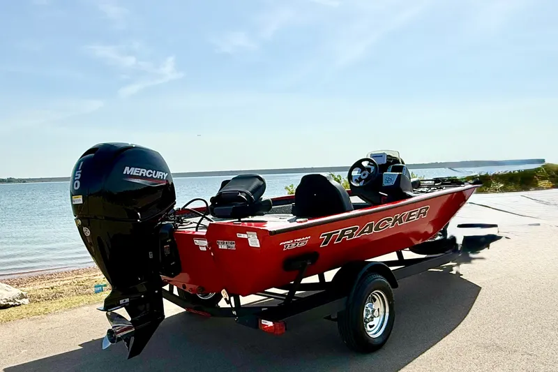 Slide: The Image of 2026 Tracker Pro Team 195 boat with Mercury engine by a serene lake. - 64