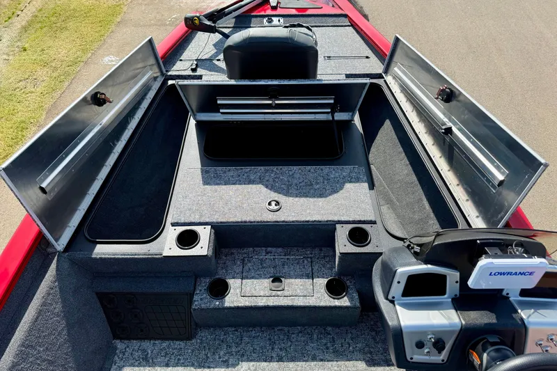Slide: The Image of 2026 Tracker Pro Team 195 boat interior with open storage compartments and Lowrance electronics. - 58