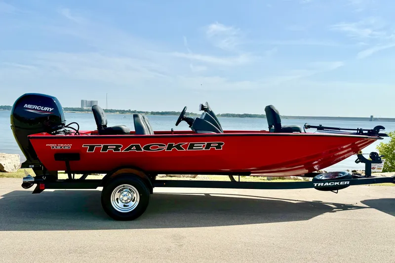 Slide: The Image of 2026 Tracker Pro Team 195 boat in vibrant red by a lakeside. - 57