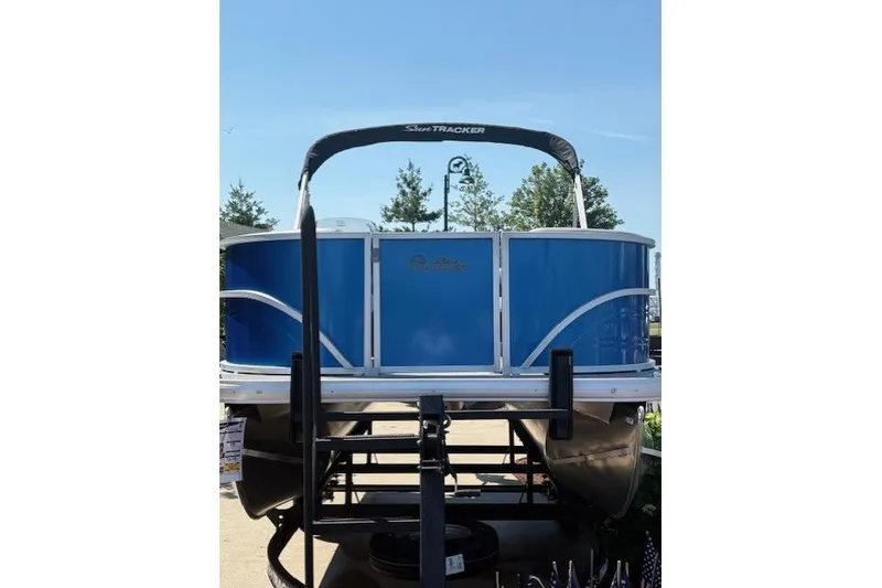 Slide: The Image of 2026 Sun Tracker Party Barge 16 DLX pontoon boat, blue exterior, displayed outdoors. - 2