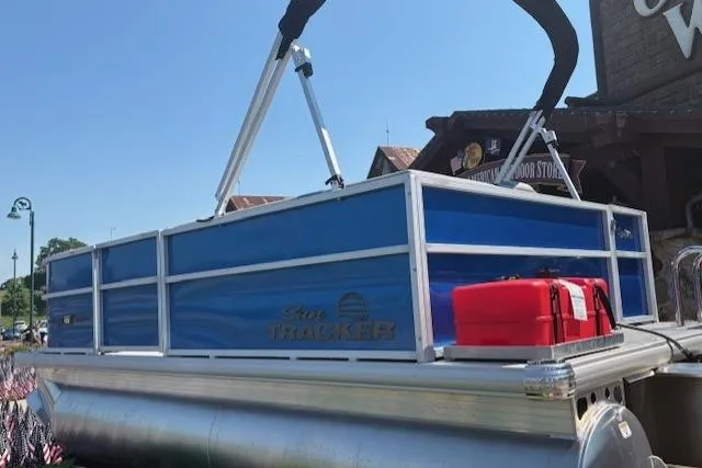 Slide: The Image of 2026 Sun Tracker Party Barge 16 DLX pontoon boat with blue panels and red fuel container. - 1