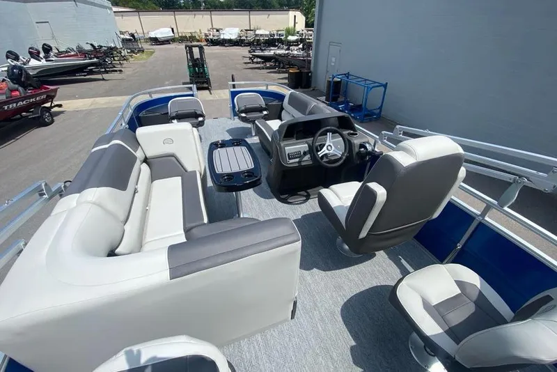 Slide: The Image of 2026 Sun Tracker Fishin' Barge 20 DLX interior with seating and steering console. - 10