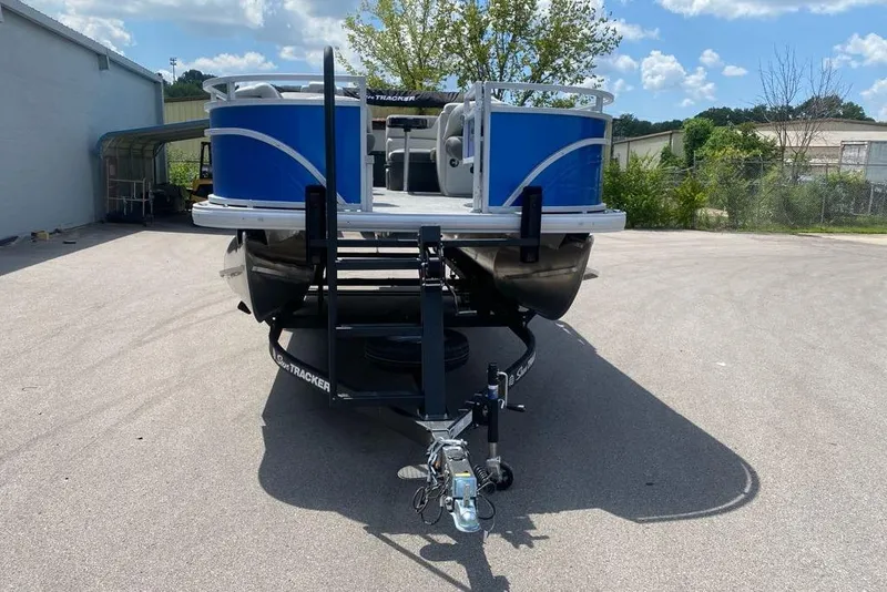 Slide: The Image of 2026 Sun Tracker Fishin' Barge 20 DLX pontoon boat on trailer, parked outdoors. - 7