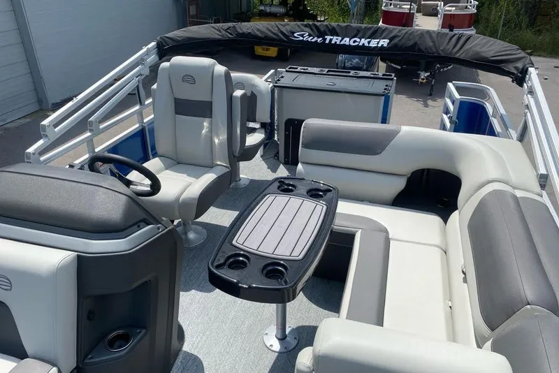 Slide: The Image of 2026 Sun Tracker Fishin' Barge 20 DLX interior with seating and table setup. - 9