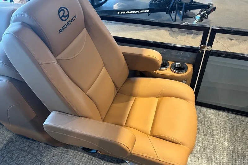 Slide: The Image of Luxurious tan leather seat in 2026 Regency 250 DL boat, featuring cup holders. - 10