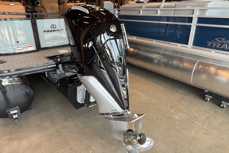 Slide: The Image of 2026 Regency 250 DL pontoon boat with powerful outboard motor in showroom. - 15