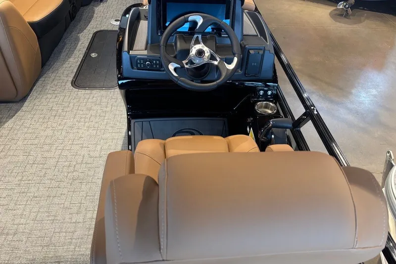 Slide: The Image of 2026 Regency 250 DL boat interior with steering wheel and tan seating. - 8