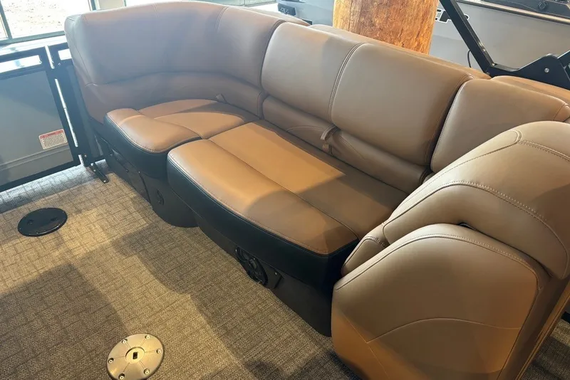 Slide: The Image of Luxurious seating in the 2026 Regency 250 DL boat, featuring plush brown upholstery. - 5