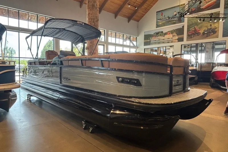Slide: The Image of 2026 Regency 250 DL pontoon boat displayed indoors with modern design features. - 13