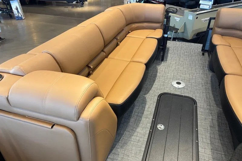 Slide: The Image of Luxurious seating inside a 2026 Regency 250 DL boat, featuring tan leather upholstery. - 11