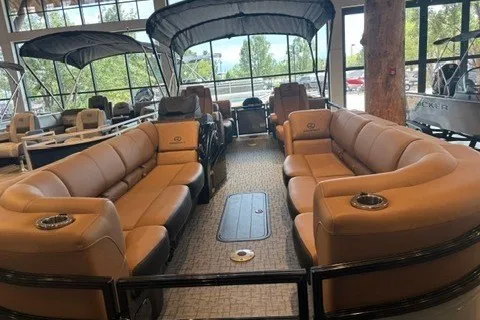 Slide: The Image of 2026 Regency 250 DL pontoon boat with luxurious seating and modern design in showroom. - 1