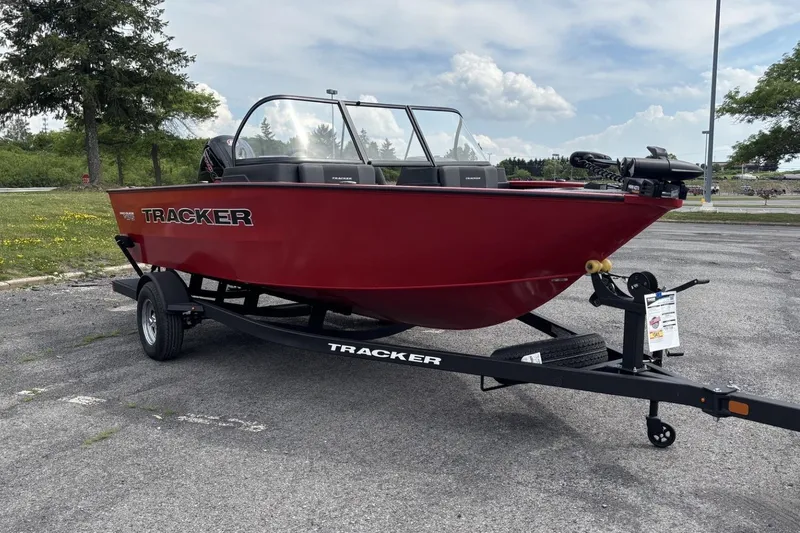 The Image of 2026 Tracker Pro Guide V-175 Combo boat on trailer, parked outdoors. - 0