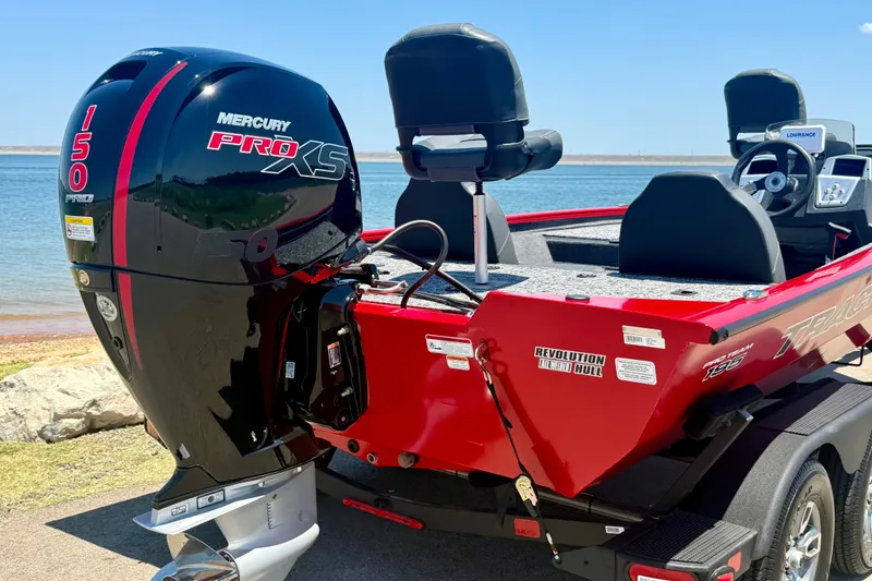Slide: The Image of 2026 Tracker Pro Team 195 boat with Mercury 150 Pro XS engine by a lake. - 17