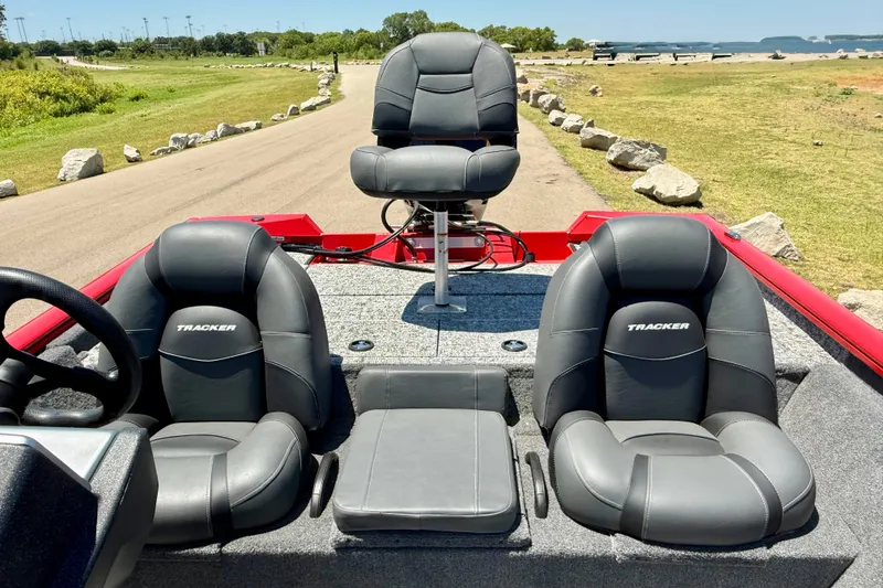 Slide: The Image of 2026 Tracker Pro Team 195 boat interior with three cushioned seats on a sunny day. - 12