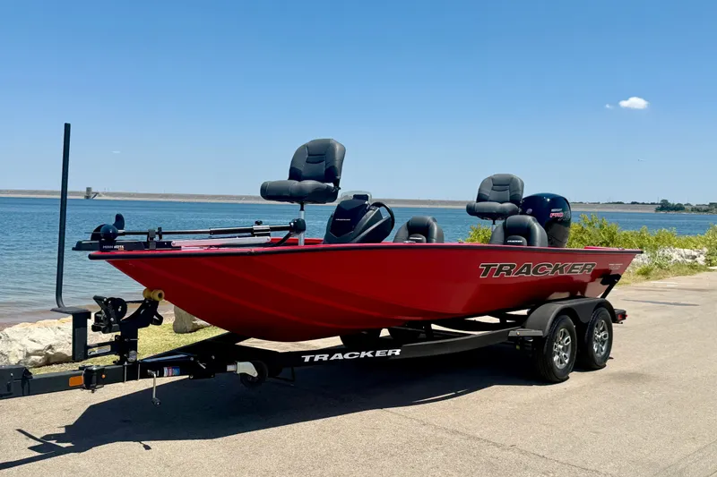 Slide: The Image of 2026 Tracker Pro Team 195 boat on trailer by a scenic lakeside. - 19