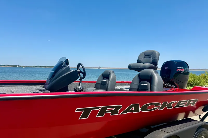 Slide: The Image of Red 2026 Tracker Pro Team 195 boat with Mercury engine by the water. - 21